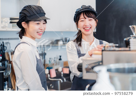 A woman working part-time at a restaurant having fun learning about her work 97558279