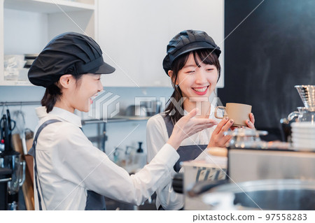 A woman working part-time at a restaurant having fun learning about her work A woman working part-time at a restaurant having fun learning about her work 97558283