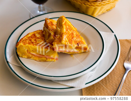 Pieces of tortilla with jamon 97558288
