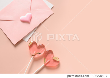 Valentine's day card with envelope and pink lollipops as heart. Valentine's day card with envelope and pink lollipops as heart. 97558397