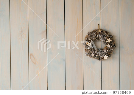 Beautiful delicate Christmas wreath on the gray wall. Copy space 97558469