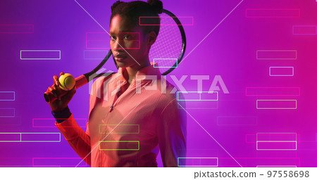 Serious biracial female tennis player with racket looking away by illuminated rectangles 97558698