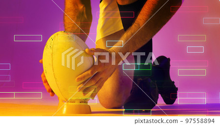 Cropped hands of caucasian rugby player placing ball on stand over illuminated rectangles Cropped hands of caucasian rugby player placing ball on stand over illuminated rectangles 97558894