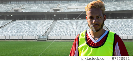 Portrait of confident biracial young male soccer player at stadium on sunny day, copy space Portrait of confident biracial young male soccer player at stadium on sunny day, copy space 97558921