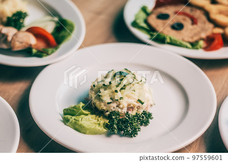 plate chicken salad with cucumber on the table 97559601