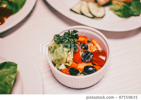 fresh vegetable salad in a white bowl on the dining table 97559635