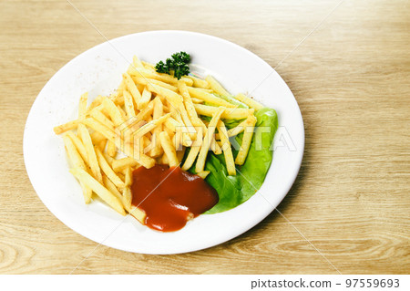 fried potatoes and sauce on a white plate 97559693
