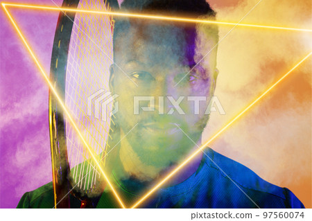 African american male tennis player with racket by illuminated triangle on smoky background African american male tennis player with racket by illuminated triangle on smoky background 97560074