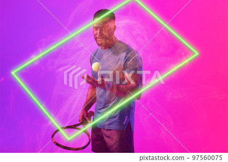 Serious african american male player with racket and ball by glowing rectangle on colored background Serious african american male player with racket and ball by glowing rectangle on colored background 97560075