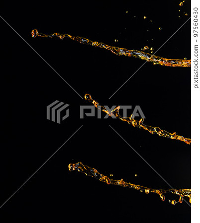 Orange, lemon juice or oil lubricant splash, liquid gold yellow drink drops. Fruit beverage water elements in line form . Fresh splashing and flowing jets, black background isolated freeze motion Orange, lemon juice or oil lubricant splash, liquid gold yellow drink drops. Fruit beverage water elements in line form . Fresh splashing and flowing jets, black background isolated freeze motion 97560430