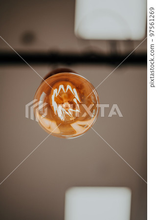 Light bulb illuminated and taken from above  97561269
