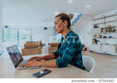 Woman sitting in living room using laptop look at cam talk by video call with business friend relatives, head shot. Job interview answering questions. Woman sitting in living room using laptop look at cam talk by video call with business friend relatives, head shot. Job interview answering questions. 97562065