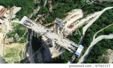 Aerial drone view on highway bridge road under construction. Construction of the viaduct on the modern new road. Aerial drone view on highway bridge road under construction. Construction of the viaduct on the modern new road. 97562157