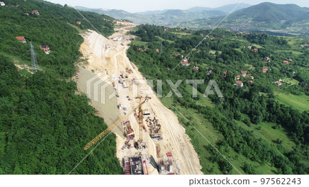 Aerial drone view on highway bridge road under construction. Construction of the viaduct on the modern new road. 97562243