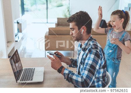 Father and daughter in modern house talking together on laptop with their family during holidays. The life of a modern family Father and daughter in modern house talking together on laptop with their family during holidays. The life of a modern family 97562631