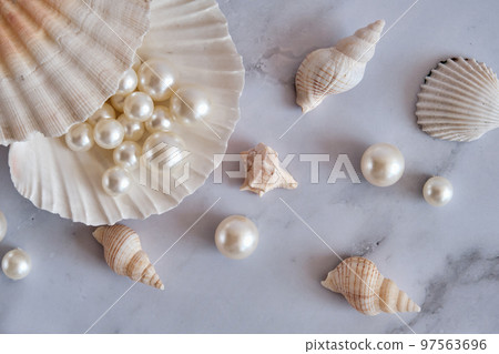 pearls in a shell on a marble background 97563696