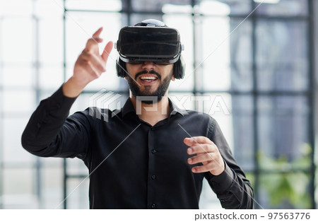 Businessman in virtual reality glasses or headset Businessman in virtual reality glasses or headset 97563776
