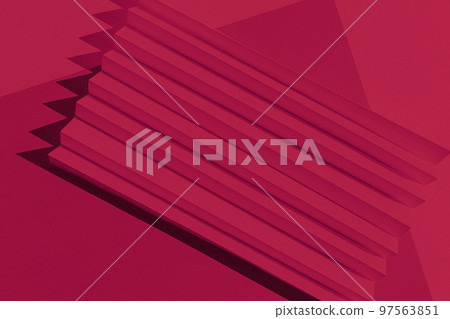 Viva Magenta color of the year 2023. Abstract crimson red color paper texture. Folded paper with harsh sun shadows, geometric shapes and lines. Viva Magenta color of the year 2023. Abstract crimson red color paper texture. Folded paper with harsh sun shadows, geometric shapes and lines. 97563851
