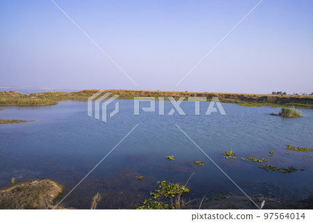 Crystal clear blue water lake landscape view nearby Padma river in Bangladesh Crystal clear blue water lake landscape view nearby Padma river in Bangladesh 97564014