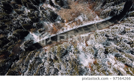 Aerial high angle view of narrow winding curvy mountain road. 97564266