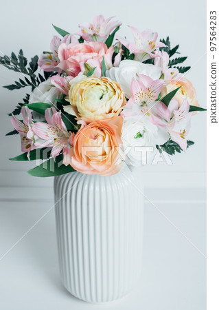 Beautiful colorful flowers in bloom in white vase. Beautiful colorful flowers in bloom in white vase. 97564283