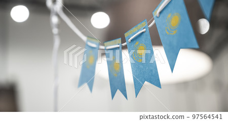 A garland of Kazakhstan national flags on an abstract blurred background 97564541