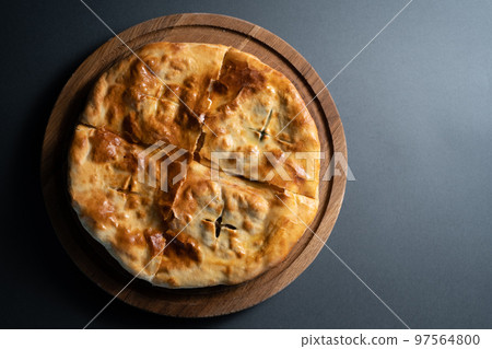 top view of traditional georgian bread khachapuri with filling on wooden board 97564800