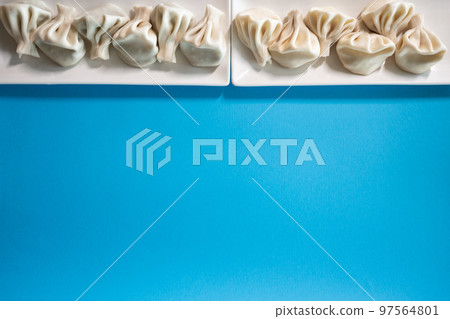 traditional georgian khinkali dumplings flatlay with copyspace, blue background 97564801