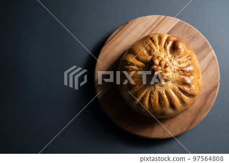 bread bowl with pilaf on wooden board on dark background, top view 97564808