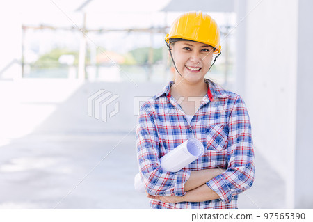 Engineer builder woman worker foreman. Portrait Asian girl architect home designer with floor plan. Engineer builder woman worker foreman. Portrait Asian girl architect home designer with floor plan. 97565390