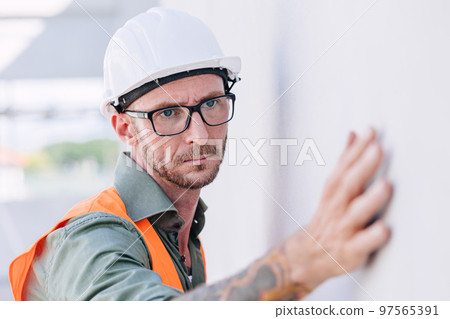 builder worker look at construction plastering wall for high precision detail and quality for good home build builder worker look at construction plastering wall for high precision detail and quality for good home build 97565391