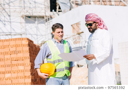 Construction builder working with Arab man project manager real estate investor for new building Construction builder working with Arab man project manager real estate investor for new building 97565392