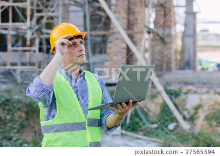 American engineer builder work in construction site. Professional foreman worker project designer leader male. American engineer builder work in construction site. Professional foreman worker project designer leader male. 97565394