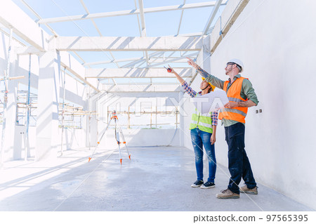 Engineer builder architect team working check progress construction of the roof structure of the building. Engineer builder architect team working check progress construction of the roof structure of the building. 97565395