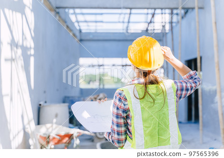 Female engineer working women. Architect construction builder worker with floor plan at building site. Female engineer working women. Architect construction builder worker with floor plan at building site. 97565396