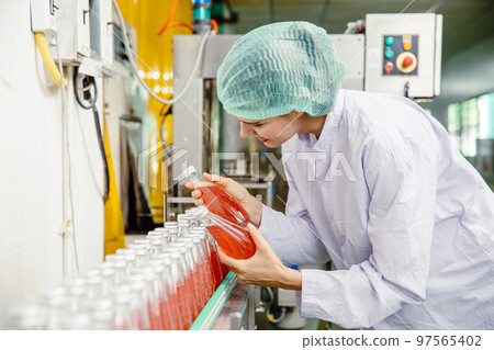 food and drink industry staff worker working at conveyor belt production line machine in beverage factory with clean and hygiene area. food and drink industry staff worker working at conveyor belt production line machine in beverage factory with clean and hygiene area. 97565402