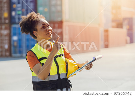 African woman cargo logistics industry staff worker happy working in port shipyard check containers African woman cargo logistics industry staff worker happy working in port shipyard check containers 97565742