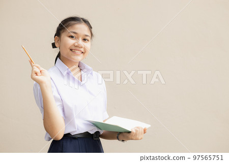 Happy Smart Asian teenager girl in school uniform cloth presentor showing creative idea isolated background 97565751
