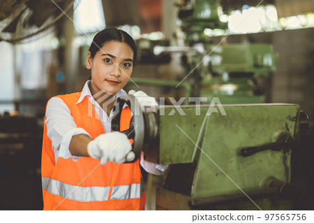 teen girl working in heavy industry with dirty lathe machine tool industry factory happy smile teen girl working in heavy industry with dirty lathe machine tool industry factory happy smile 97565756