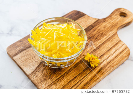 Chrysanthemum petals in a glass container Chrysanthemum petals in a glass container 97565782