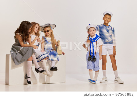 Portrait of children, boys and girls posing over grey background. Meeting, travelling, cruise fun 97565992