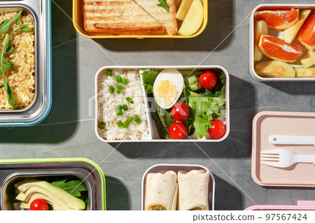 Containers with healthy food on gray background top view. 97567424