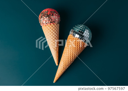 Christmas fun decorative fake ice cream cone on dark green background Christmas fun decorative fake ice cream cone on dark green background 97567597