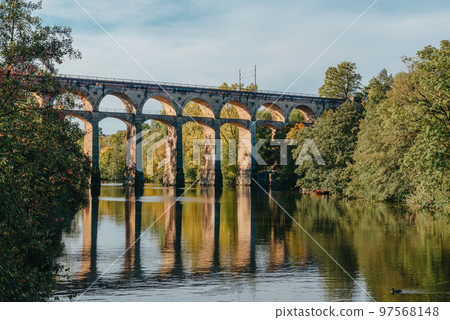 Railway Bridge with river in Bietigheim-Bissingen, Germany. Autumn. Railway viaduct over the Enz River, built in 1853 by Karl von Etzel on a sunny summer day. Bietigheim-Bissingen, Germany. Old 97568148