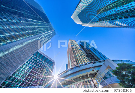 Tokyo cityscape in Japan Diamond Shiodome in winter. Shiodome office district and Yurikamome line with clear blue sky in winter 97568306