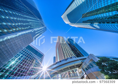 Tokyo cityscape in Japan Diamond Shiodome in winter. Shiodome office district and Yurikamome line with clear blue sky in winter 97568309