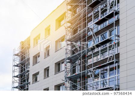 Renovation of a multistory building with scaffolding Renovation of a multistory building with scaffolding 97568434