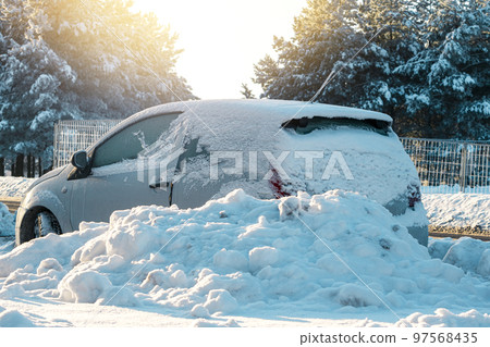 The car parked on the street after heavy snowfall The car parked on the street after heavy snowfall 97568435