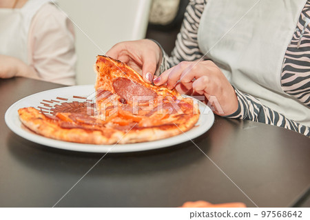 close up. small participants of the master class eat pizza close up. small participants of the master class eat pizza 97568642