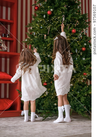 Cute little curly-haired girls in night dresses... - Stock Photo [97569107]  - PIXTA